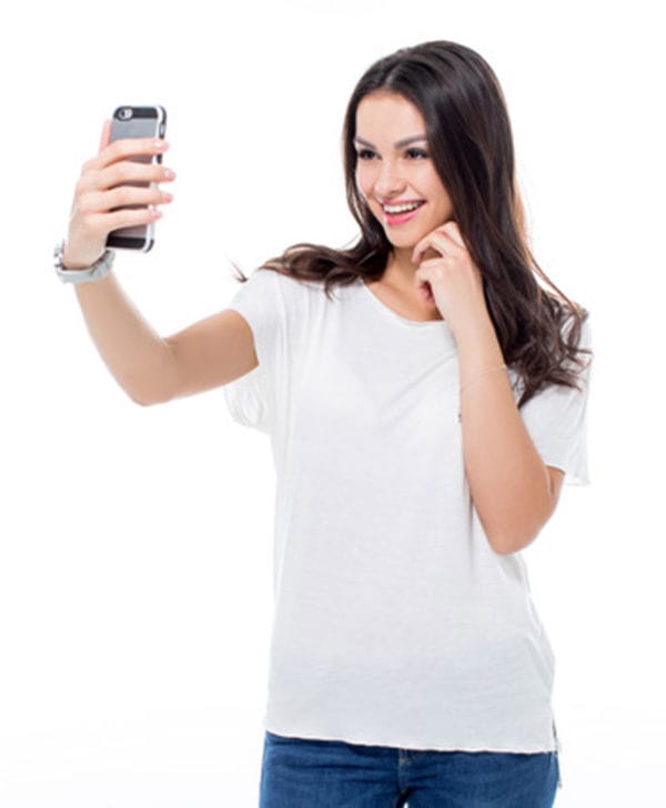 woman in white shirt taking a selfie